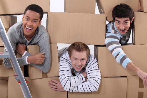 Removal team preparing a Docklands apartment move with boxes and protective wrapping